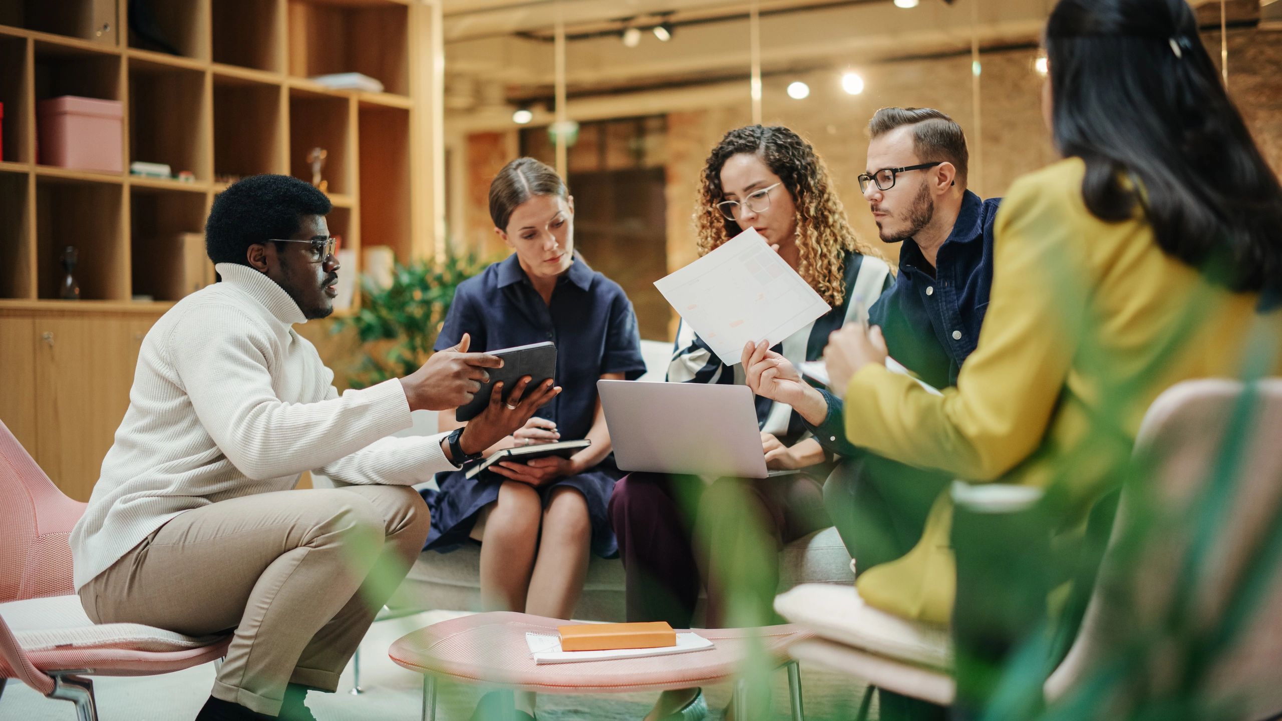 Consulting team reviewing strategic plans in a modern office